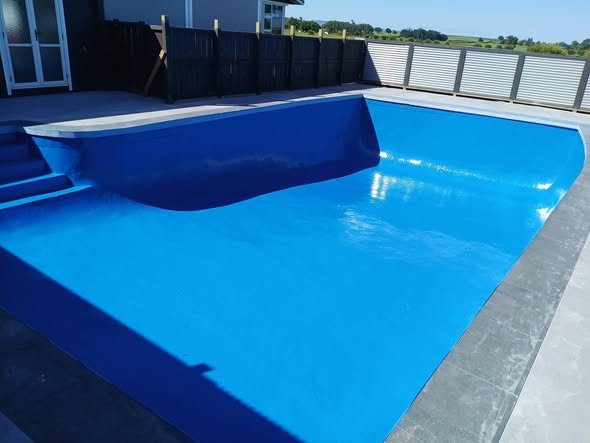 Freshly refurbished blue fibreglass pool by Matamata Paint and Plaster